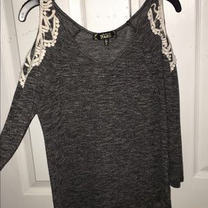 Grey quarter sleeve shirt with shoulder cut outs.